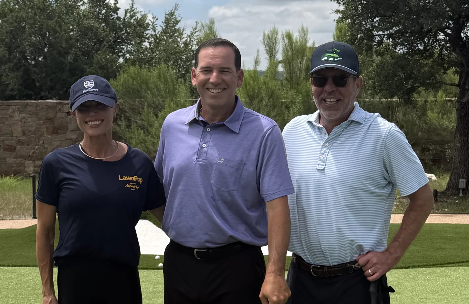 LawnPop owners Tanner and Angie Shepard with professional golfer Sergio Garcia on an artificial turf putting green