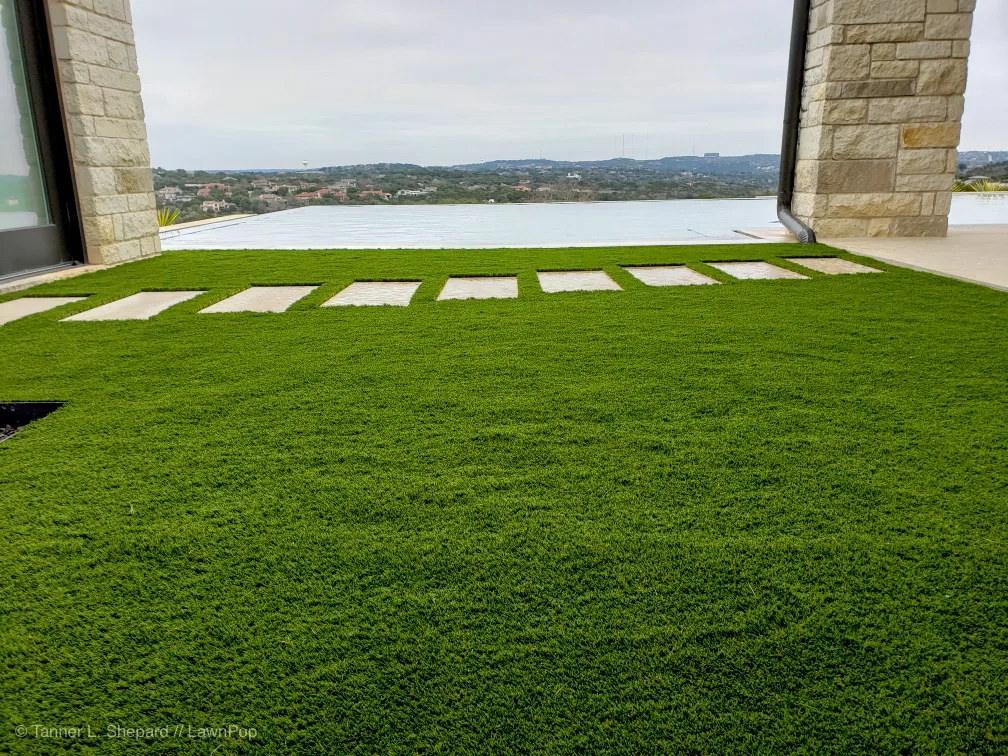 Artificial turf with paver stepping stones overlooking a lake