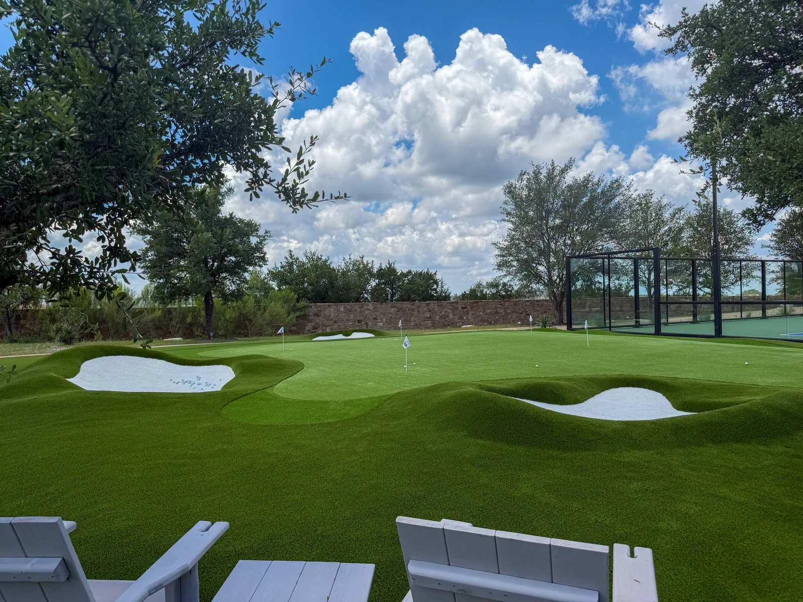 Putting and chipping green with bunkers at Sergio Garcia's Austin home, designed by LawnPop